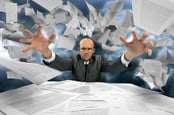 Man vs paperwork. Paper-pusher loses control. Photo by Shutterstock