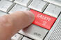 A finger pressing a delete key