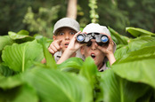 Boy with binoculars photo via Shutterstock