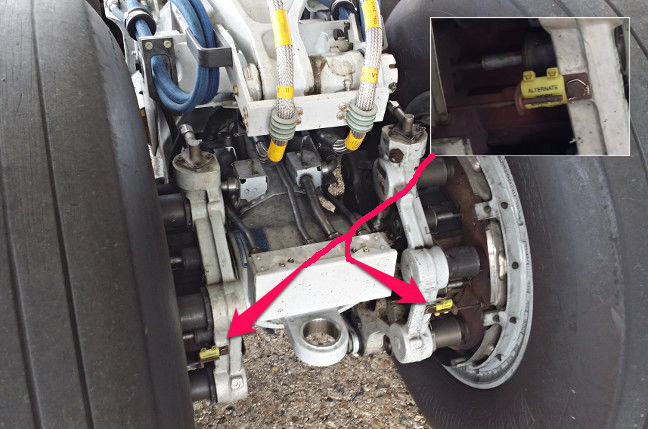 Detail of the starboard landing gear. Inset: the brake condition monitoring pin