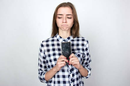 Annoyed holding cracked, shattered screen smartphone