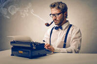 faux old-school reporter with suspenders, pipe and typewriter