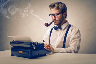 faux old-school reporter with suspenders, pipe and typewriter