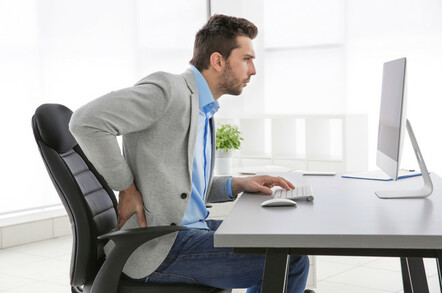 man in pain at workstation