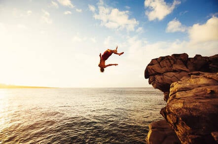 A man diving from a cliff