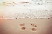 Footprints sand photo via Shutterstock
