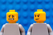 angry lego minifig man turns on anxious lego minifig man