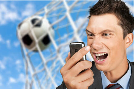 Man looking at phone misses goal being scored.