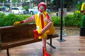 Ronald McDonald character sitting on the couch at Mccafe Star Avenue in Bangkok ,Thailand 