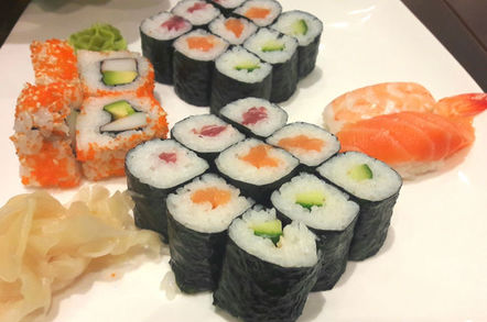 Sushi platter containing uramaki, hosomaki, nigiri and California roll with picked ginger and wasabi