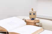 Robot reading photo via Shutterstock