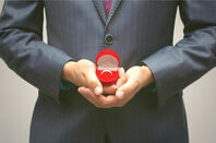 man proffers ring in box... 