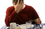 depressed man dines at empty plate