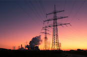 Power plant + electricity pylons at sunset