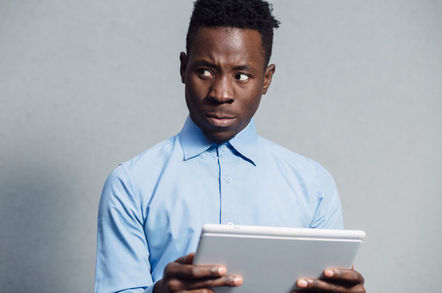 Man looks put off by something he's seen on a tablet