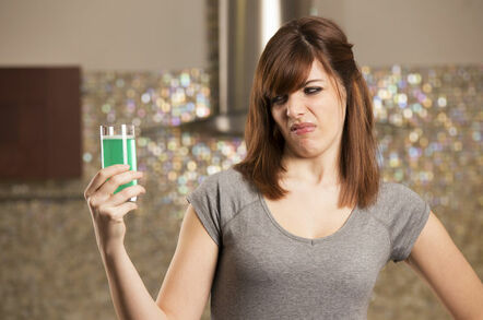 woman drinks vile green liquid