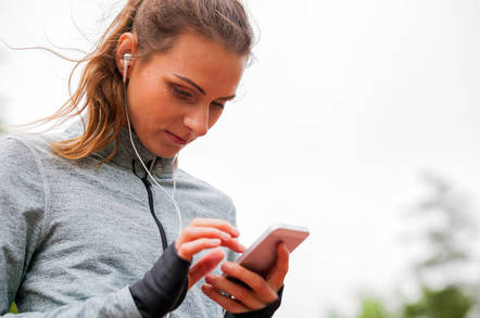 Healthy looking person uses app on phone.