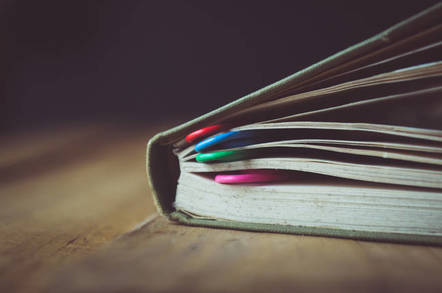 Book bookmarked with paper clips
