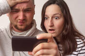 Couple shocked by something on a smartphone