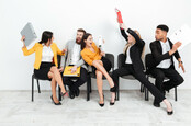 staff in business suits thrash each other with ring binders