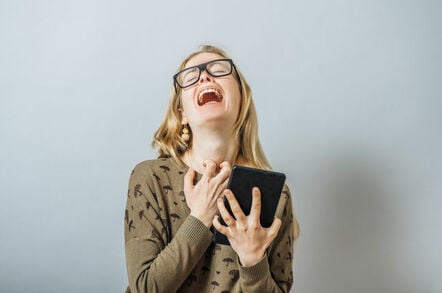 Woman wails in despair while clutching a tablet.