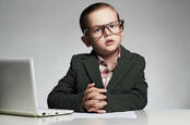 Child wearing a suit and using a computer