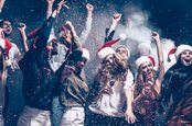 Young folk partying in Christmas hats