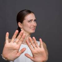 A woman holding her hands up to say, er, no thanks