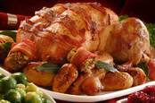 Christmas turkey wrapped in bacon with Brussels sprouts on the side