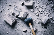 sledgehammer reduces cement block to powder