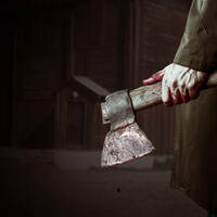 man walks with bloody axe