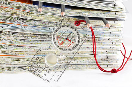 ORDNANCE SURVEY MAP STACK WITH COMPASS AND PENCILS