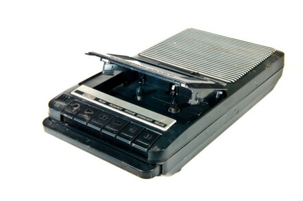 old Cassette Tape player and recorder on a white background... the play and record keys are blurred from use.
