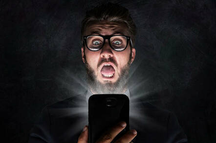 nerd looking surprised at phone