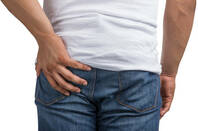 Man holds hurt bottom 