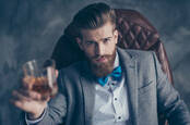 bearded gentleman raises glass