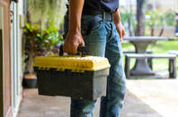 technician holding a toolbox