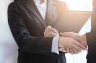 Man and woman shake hands - business deal