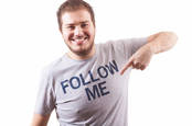 Guy pointing at a shirt reading 'Follow me'