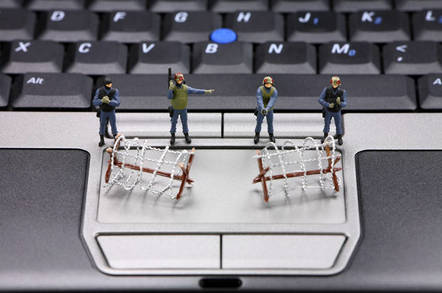 Miniature SWAT team guarding laptop keyboard