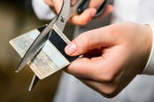 Person cutting up their payment card