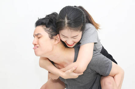 Man piggybacks woman