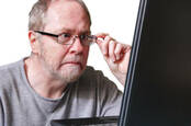 Man possibly shocked at what he's seeing on computer screen