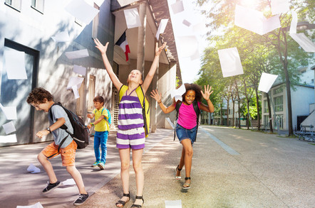 schoolchildren celebrate - throw papers in the air