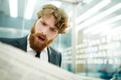 man shocked when reading newspaper