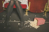 Woman accidentally kicks over bucket of popcorn in cinema
