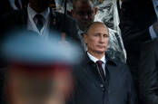 President Vladimir Putin surrounded by aides and soldiers