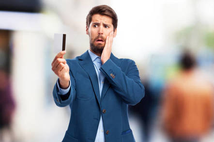 man looks worried with credit card