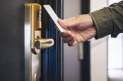 Man opens hotel room with key card