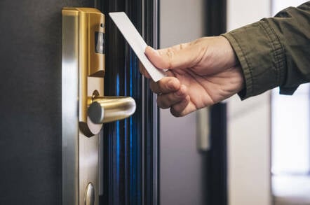 Man opens hotel room with key card